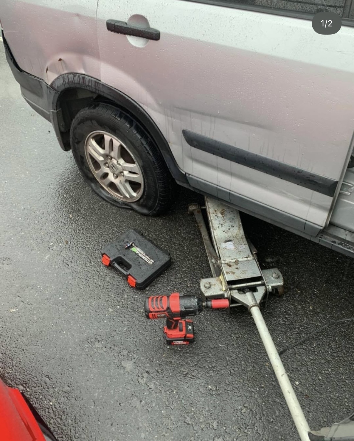 Reliable Roadside technician changing a flat on a Honda CR-V in Atlanta